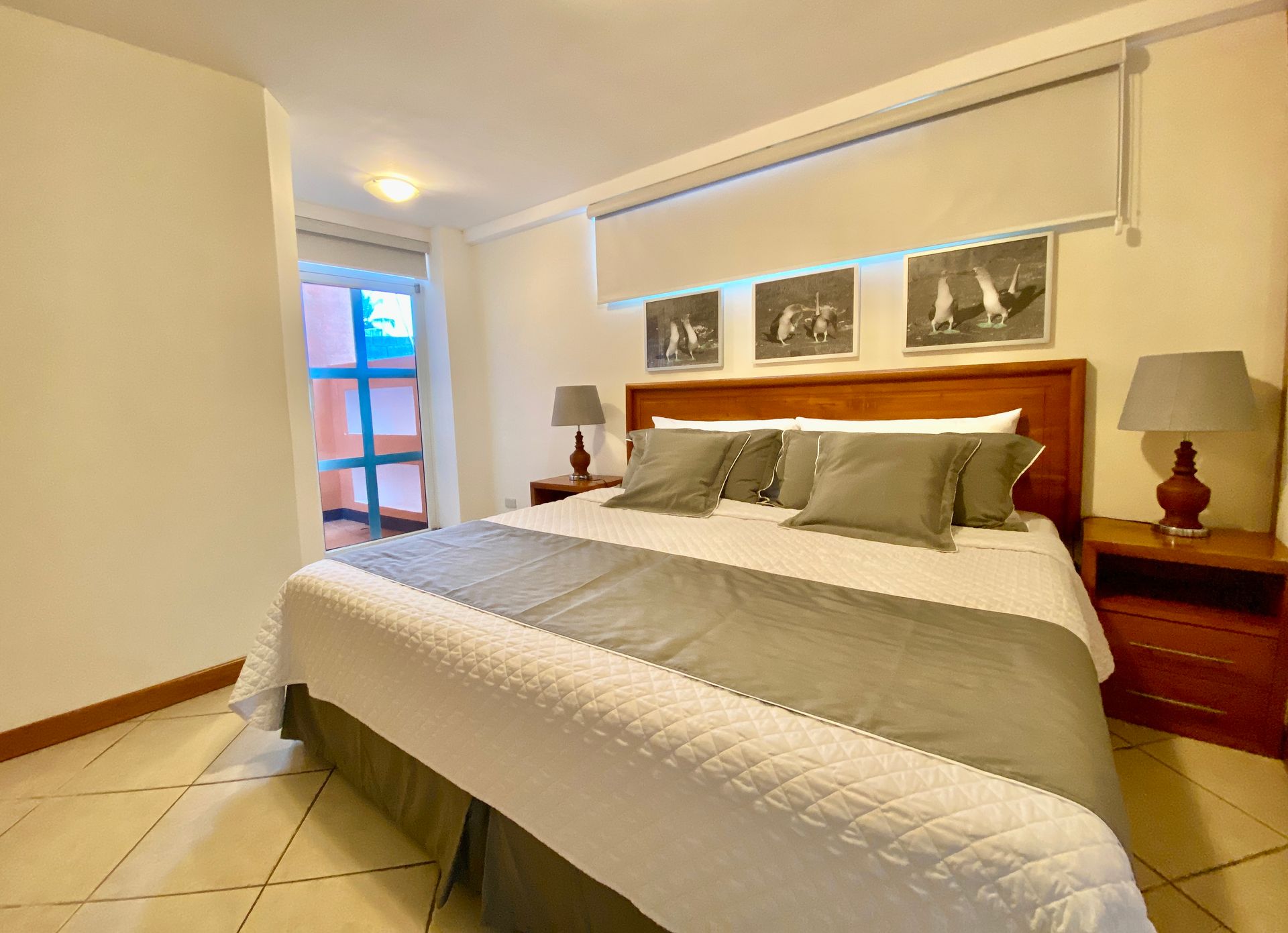 A bedroom with a king size bed and two nightstands