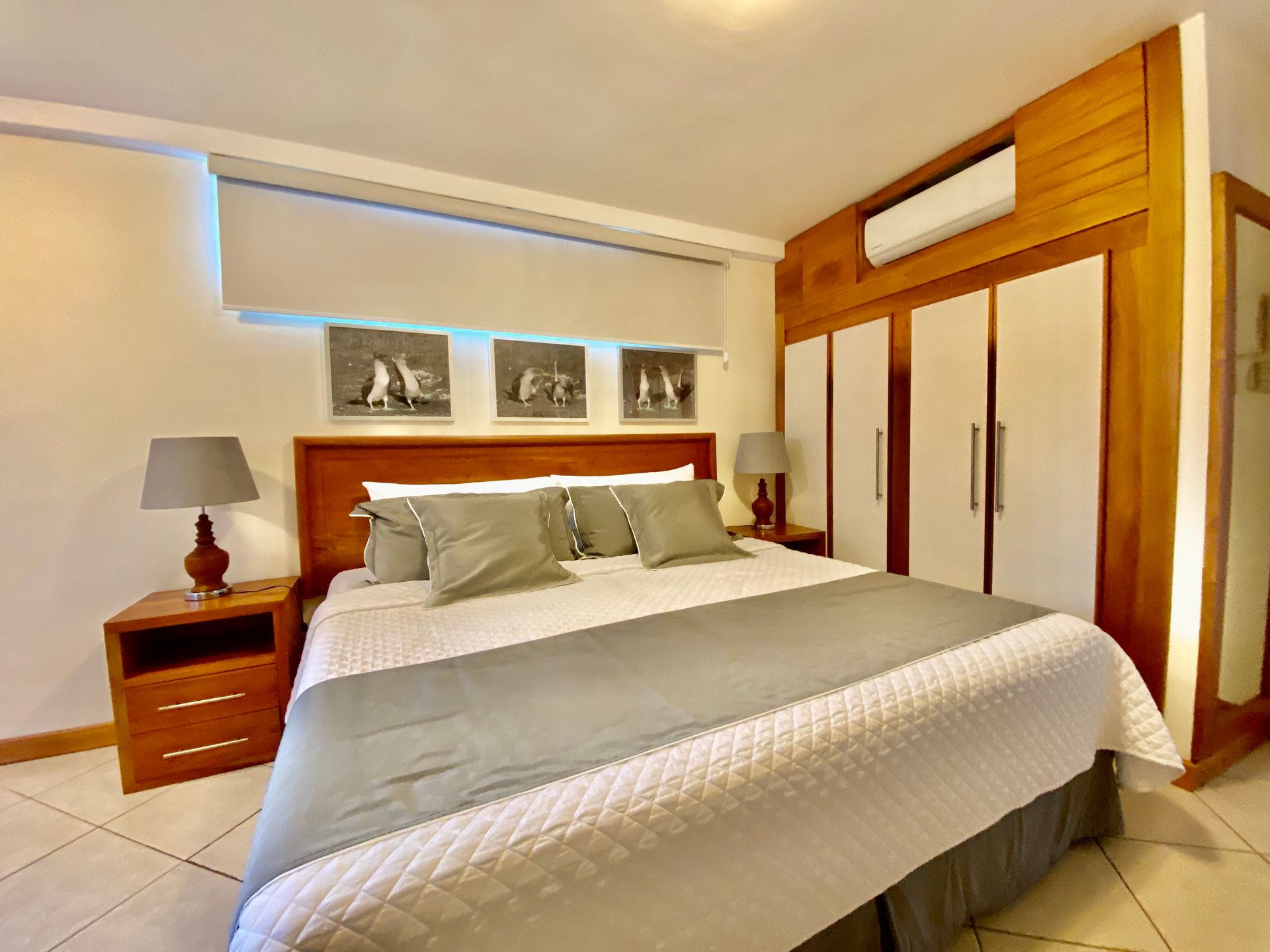 A bedroom with a king size bed and a nightstand