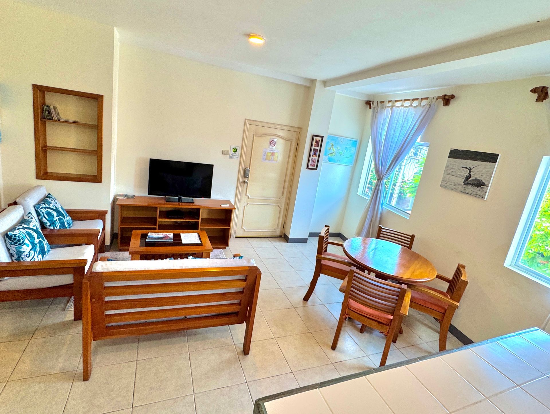 Cozy living space with wooden furniture, a TV, and a dining area.
