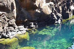 There is a large body of water surrounded by rocks.