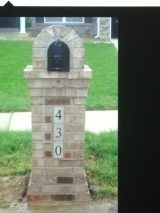 A brick mailbox with the number 430 on it