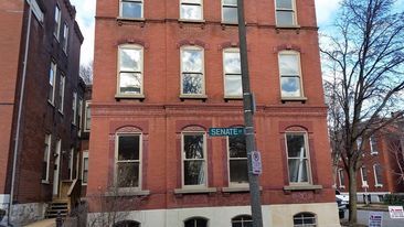 A brick building with a street sign that says spencer street