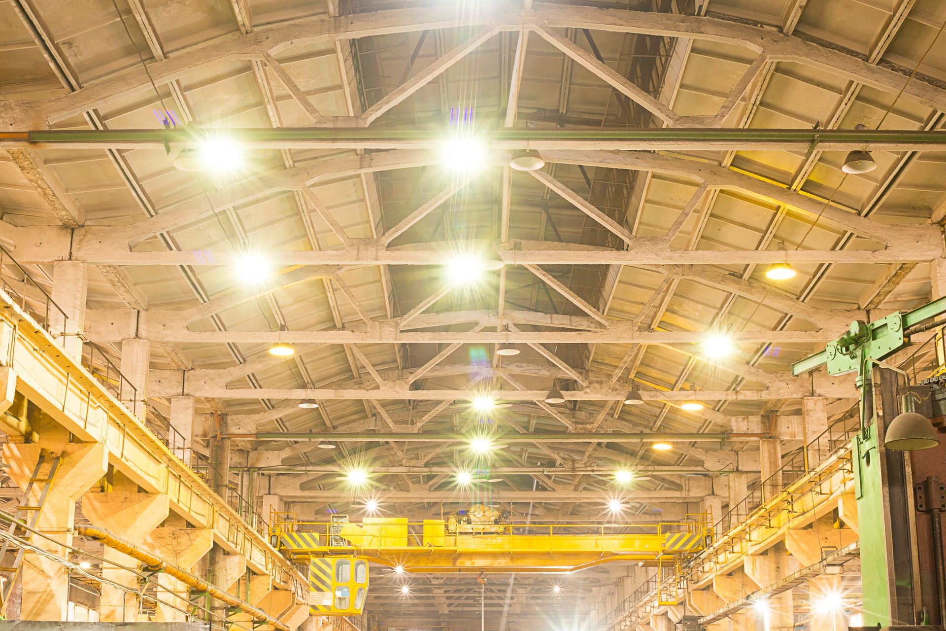 A large warehouse with a lot of lights on the ceiling.