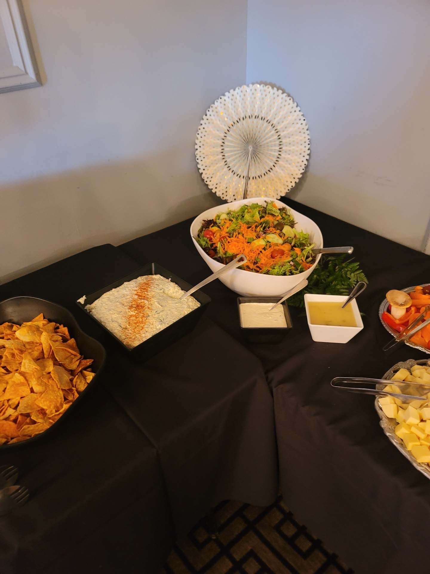 A table with plates of food and a bowl of salad on it