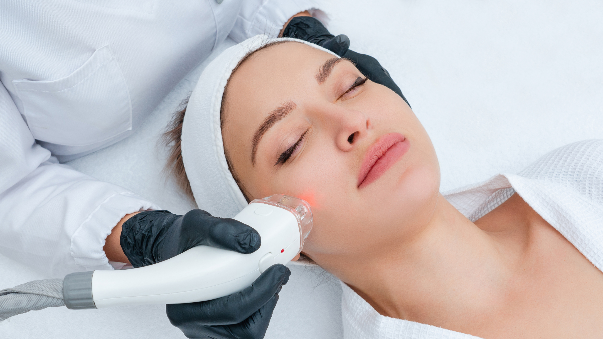 A woman is getting a facial treatment at a beauty salon.