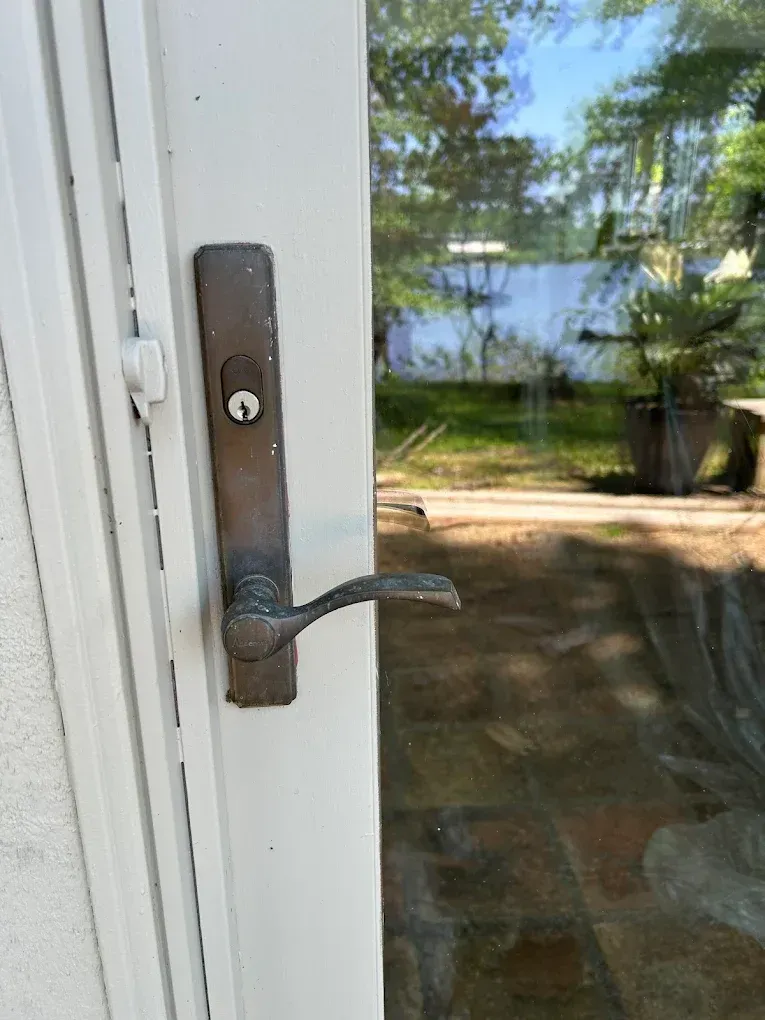 White door with a dark metal handle and lock.