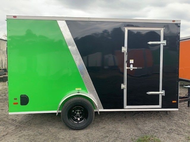 Green and black enclosed trailer with a black wheel, silver door and trim.
