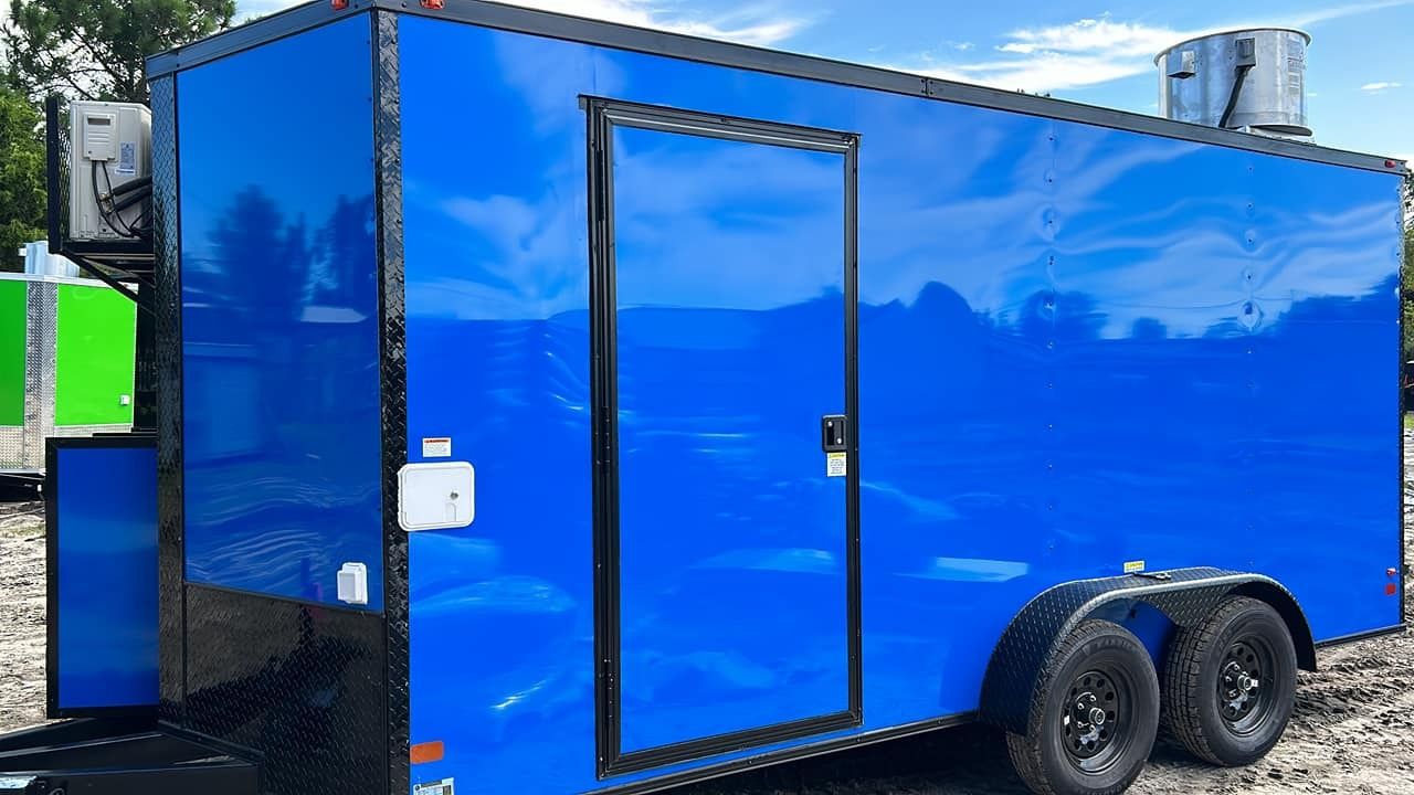 Blue food trailer with black trim and wheels.