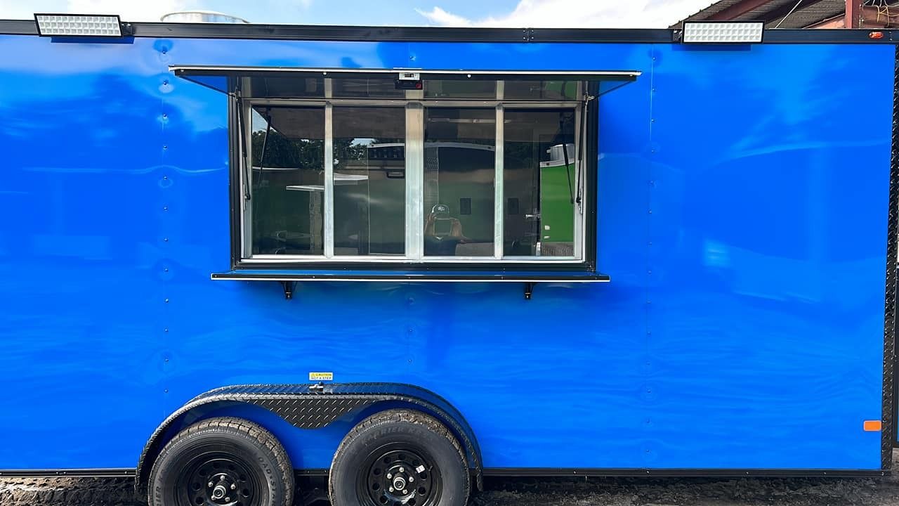 Blue food truck with large window; two black tires.