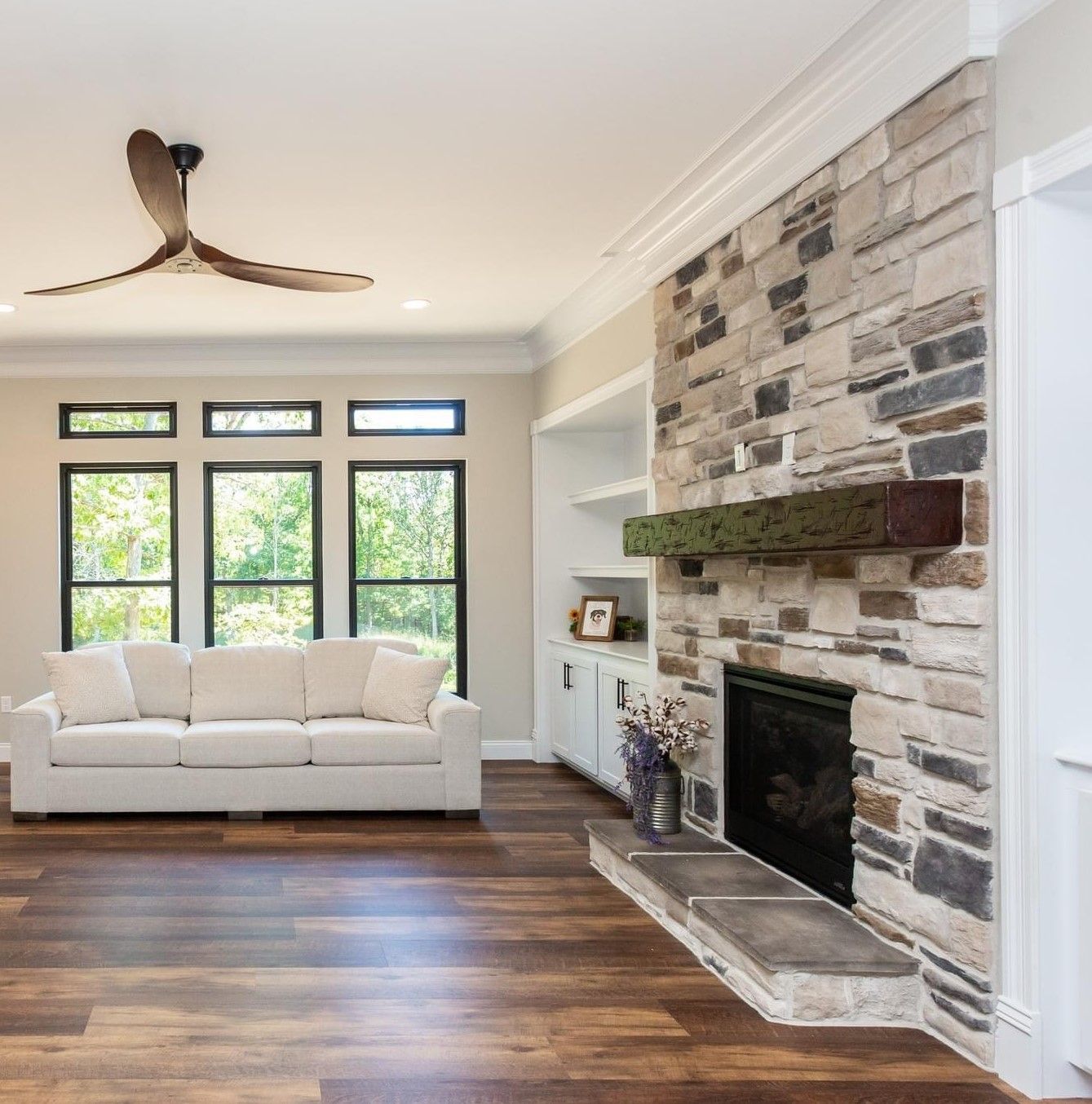 A brick fireplace surrounded by logs in a living room