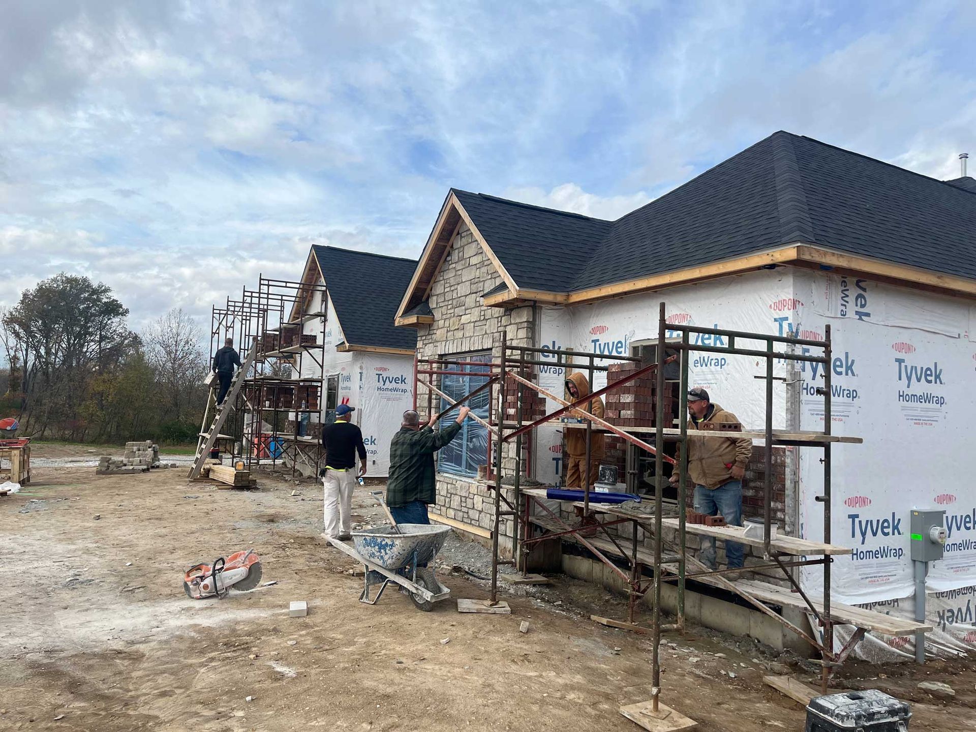 A group of people are working on a house under construction.