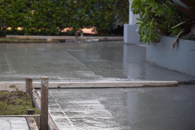 Freshly Poured Concrete Patio With Wooden Guides — Easy Mix Concrete In Berkeley Vale, NSW