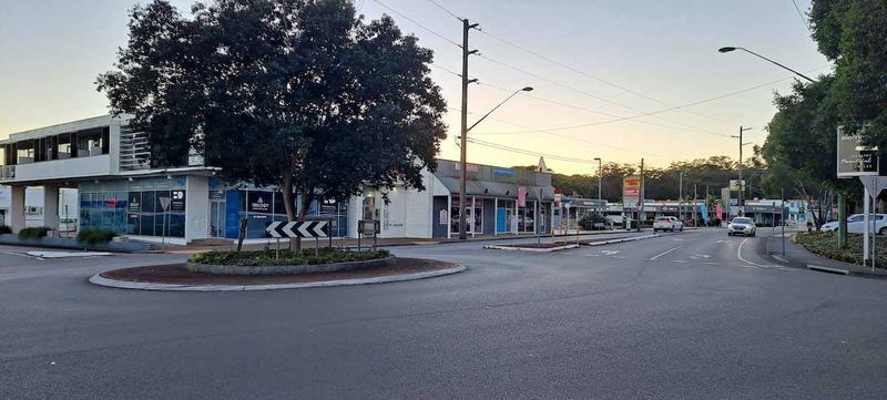 Road With Buildings and a Roundabout, Dusk Setting— Easy Mix Concrete In Erina, NSW