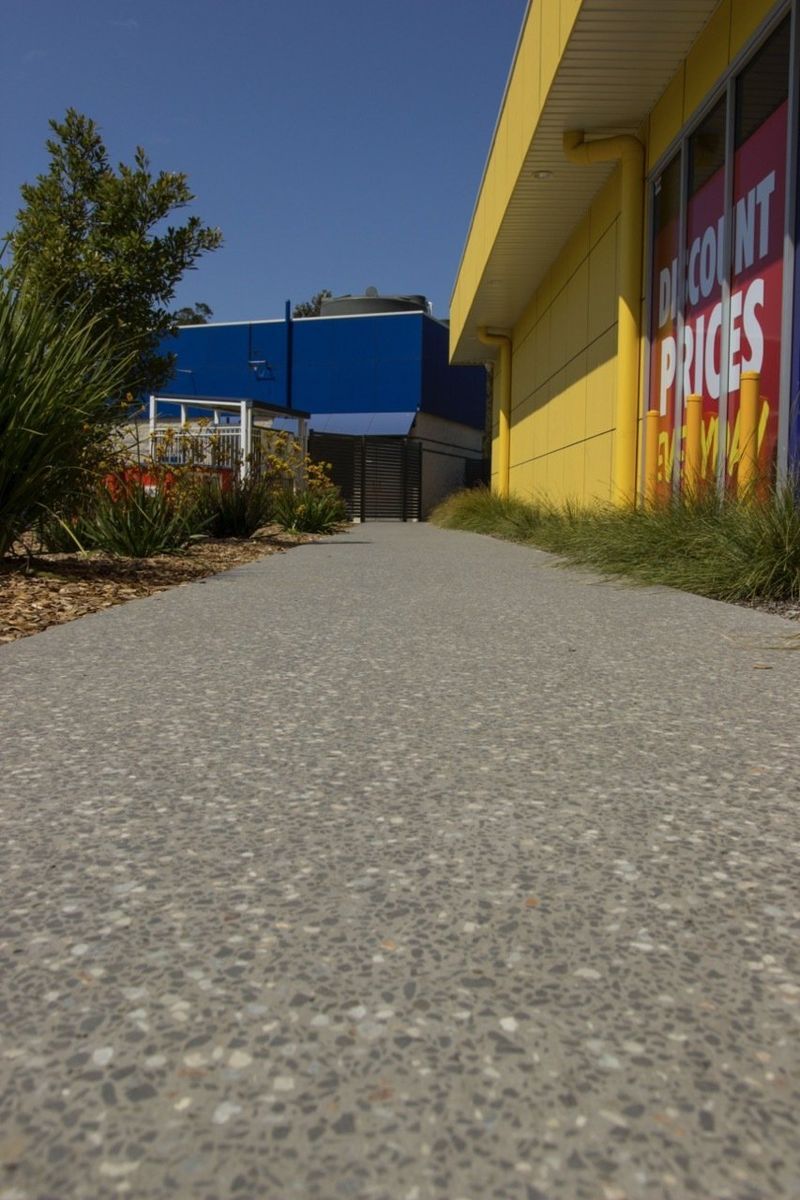 Concrete Path Leading Towards a Yellow Building — Easy Mix Concrete In Berkeley Vale, NSW