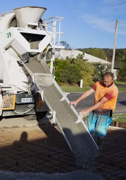 A Construction Worker Pouring Concrete — Easy Mix Concrete In Berkeley Vale, NSW