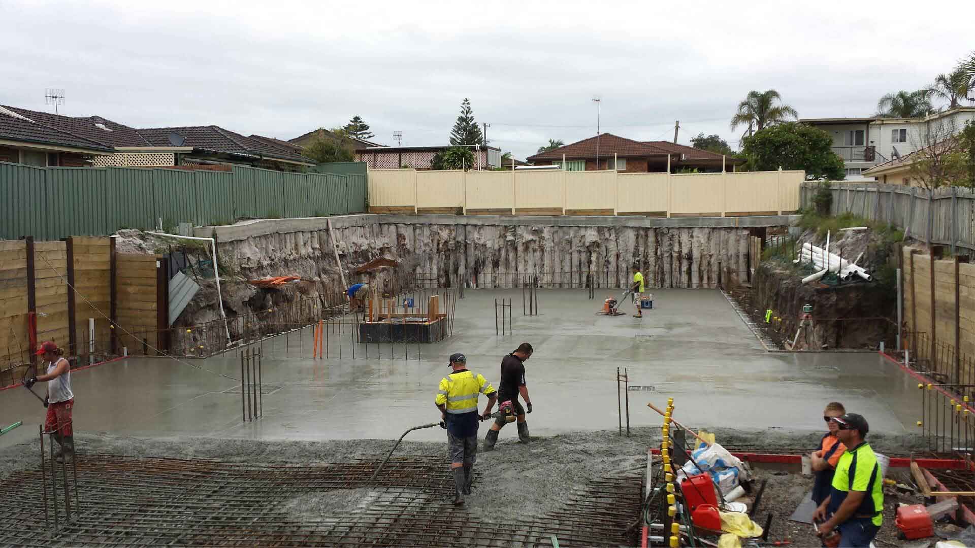 Construction Site With Workers Pouring Concrete — Easy Mix Concrete in Berkeley Vale, NSW