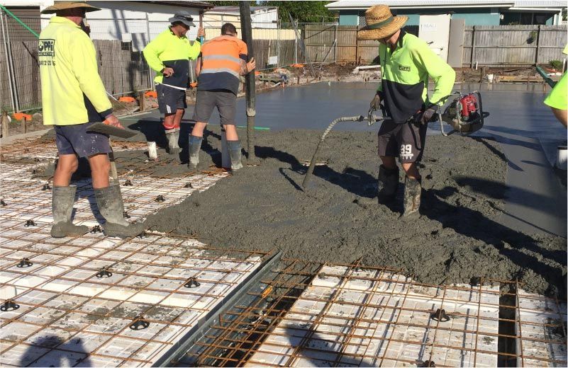 Construction Workers Pouring Concrete on a Reinforced Slab — Easy Mix Concrete in Berkeley Vale, NSW