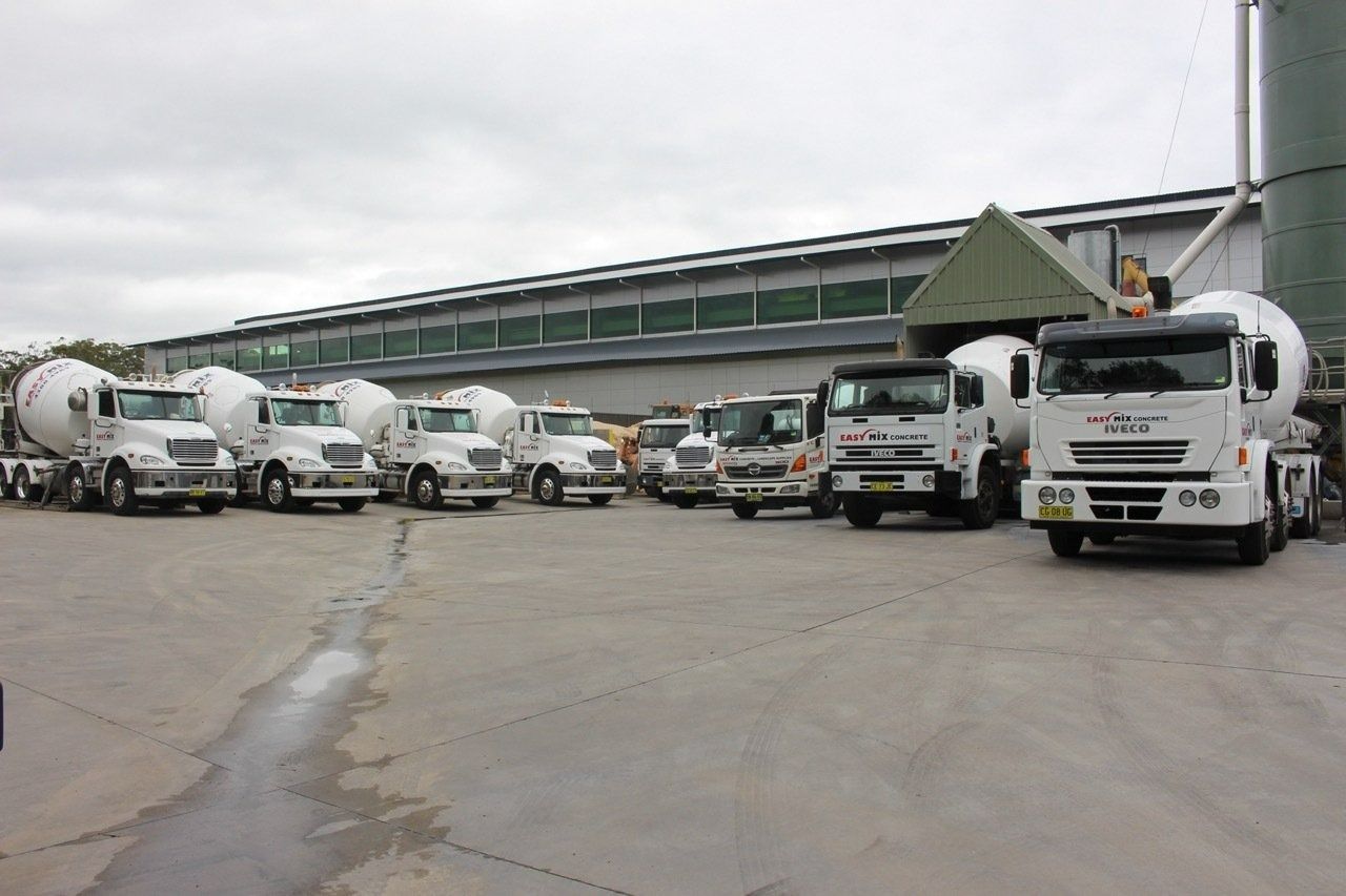 Cement Trucks Parked in Front of a Building — Easy Mix Concrete In Berkeley Vale, NSW