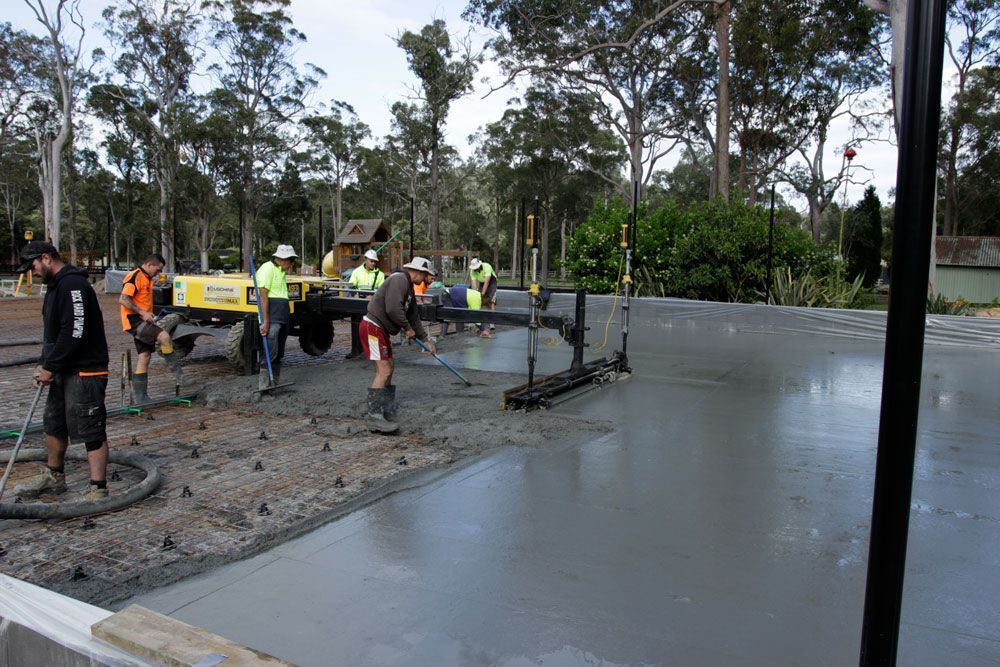 Construction Workers Smoothing Wet Concrete — Easy Mix Concrete In Berkeley Vale, NSW