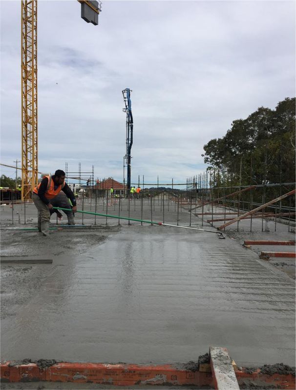 Construction Worker Smoothing Wet Concrete — Easy Mix Concrete In Berkeley Vale, NSW