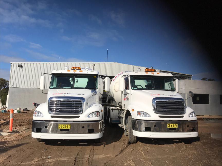 Two White Cement Mixer Trucks Parked — Easy Mix Concrete in Berkeley Vale, NSW