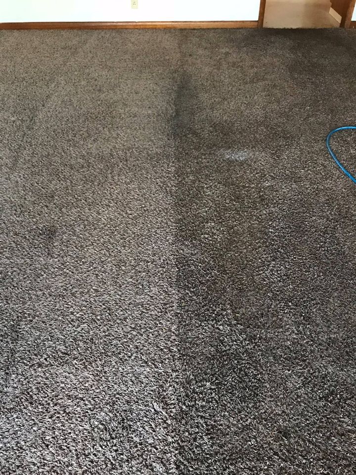 A close up of a gray carpet in a living room.