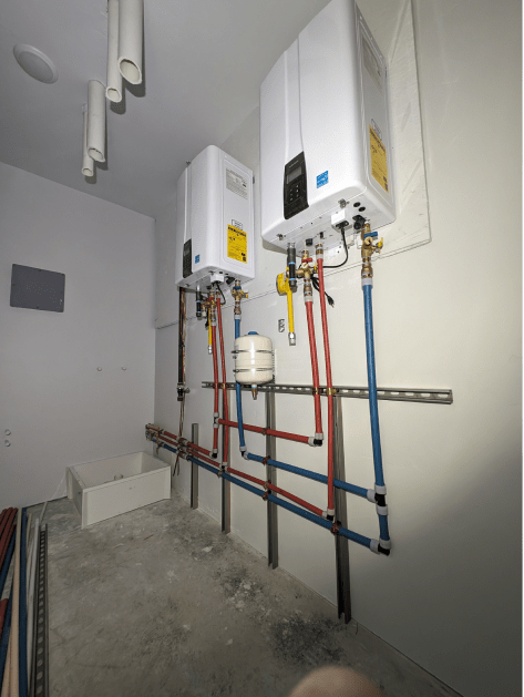 A room with a lot of pipes hanging from the wall