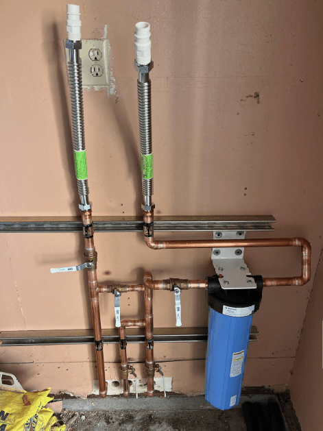 A copper pipe with a blue filter attached to it