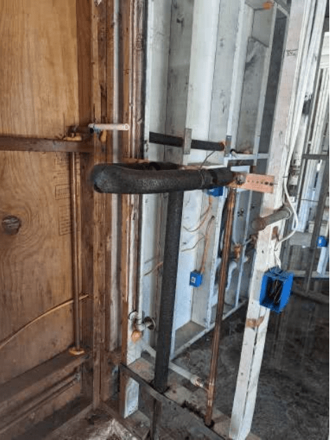A ladder is attached to a wooden wall in a room.