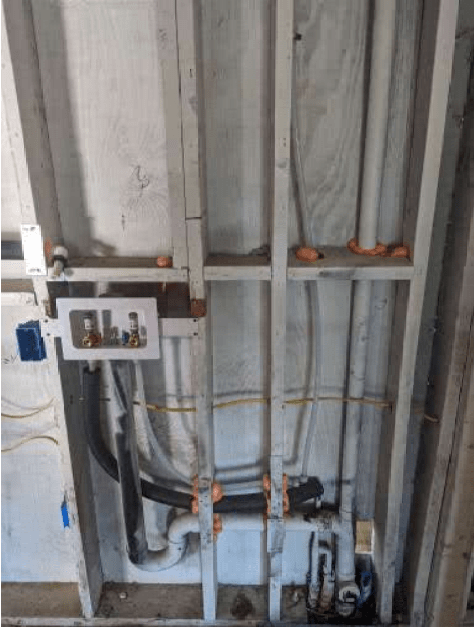 A bunch of pipes are hanging from the ceiling in a room.