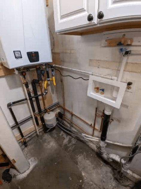 A laundry room with a washer and dryer and a sink.