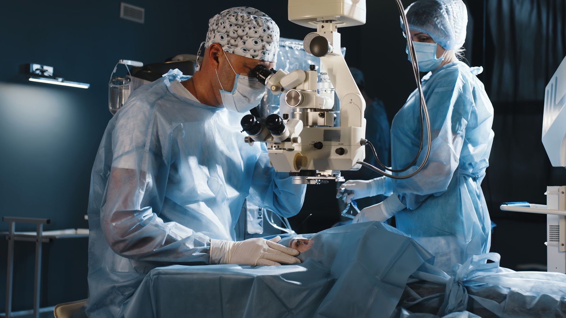A surgeon looks through a microscope in the operating room. 