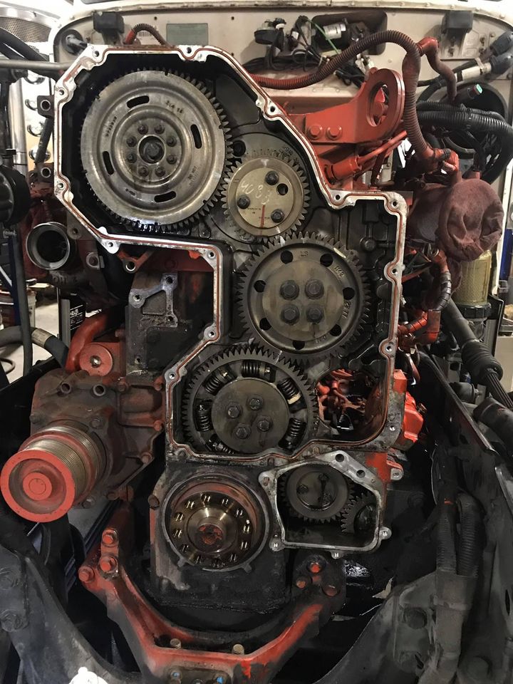 A close up of a tractor engine being worked on in a garage.