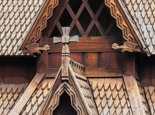 A wooden roof with a cross on top of it