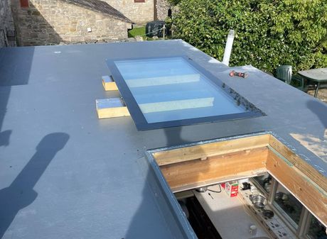 A roof with a skylight in the middle of it