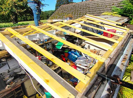 A man is working on the roof of a house.