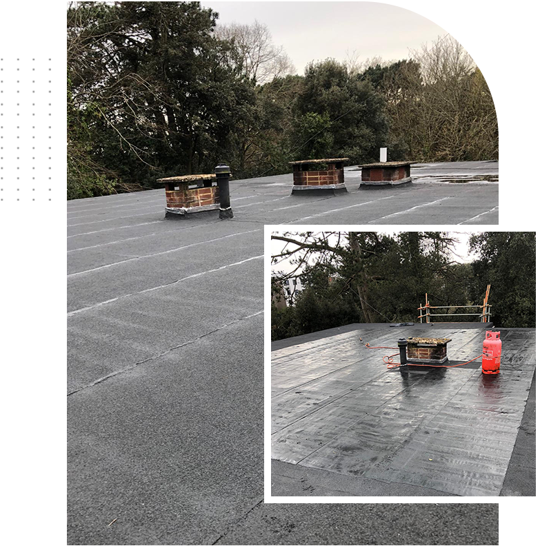 A picture of a roof with chimneys and trees in the background