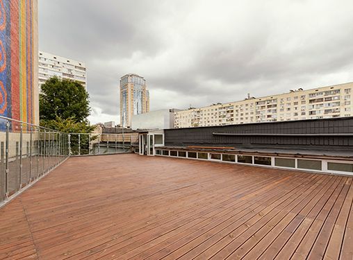 There is a large wooden deck on the roof of a building.