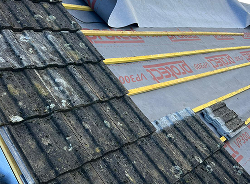 A close up of a roof with a roofing material on it.