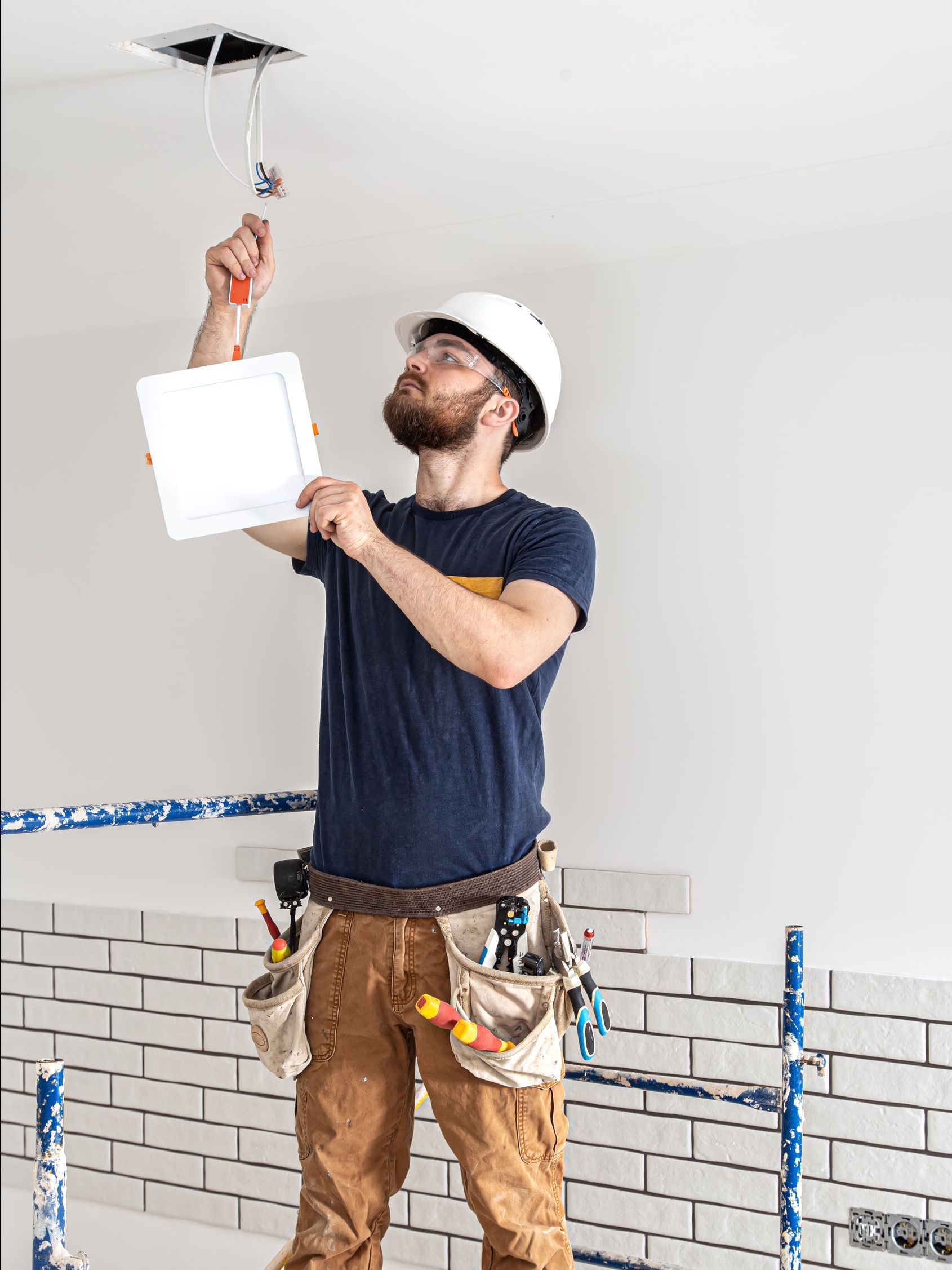 residential electrician during lighting installation service