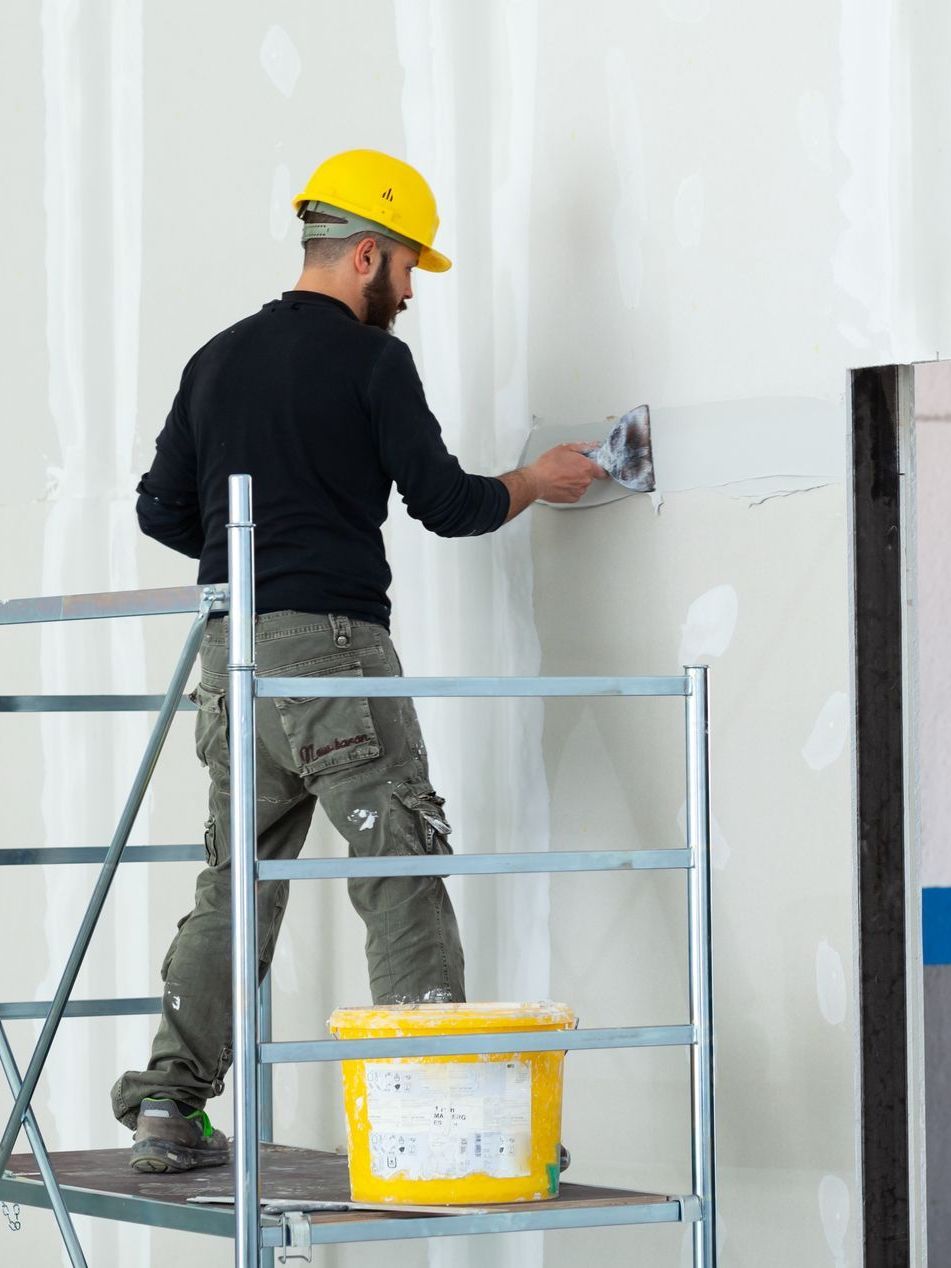 Professional contractor during commercial drywall installation