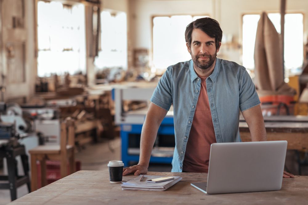 Man Standing At A Table — Michael Andrews Taxation & Accounting Services In Pacific Paradise, QLD