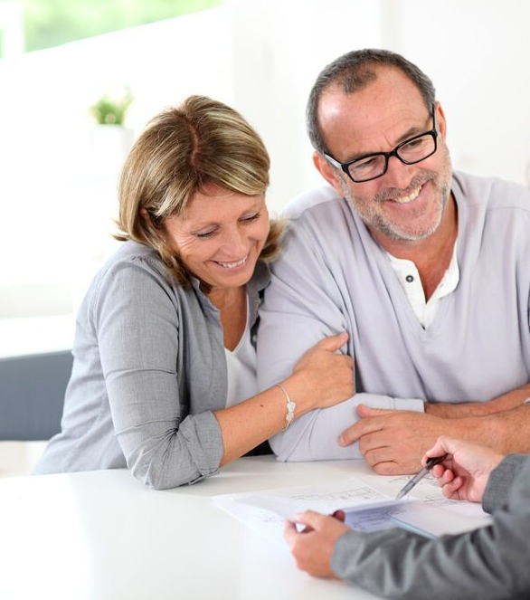 Happy Couple Being Shown Their Tax By An Accountant — Michael Andrews Taxation & Accounting Services In Pacific Paradise, QLD