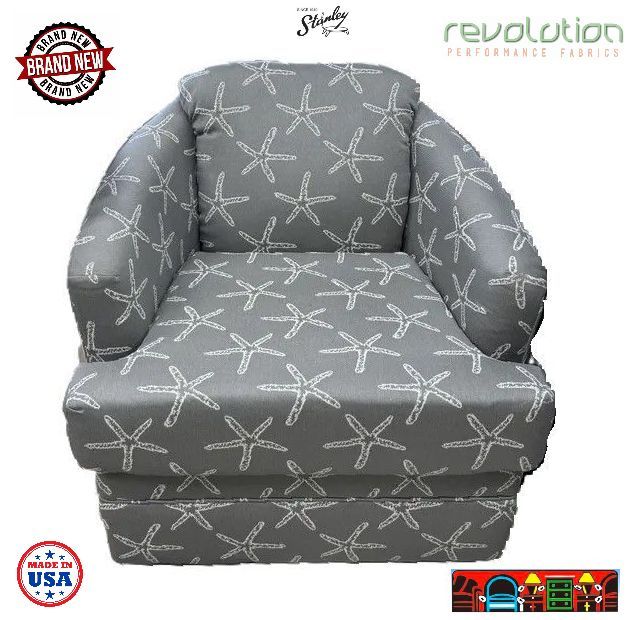 'A coastal swivel barrel chair featuring a reversible cushion, upholstered in a grey performance fabric adorned with white starfish. Proudly made in the USA!'