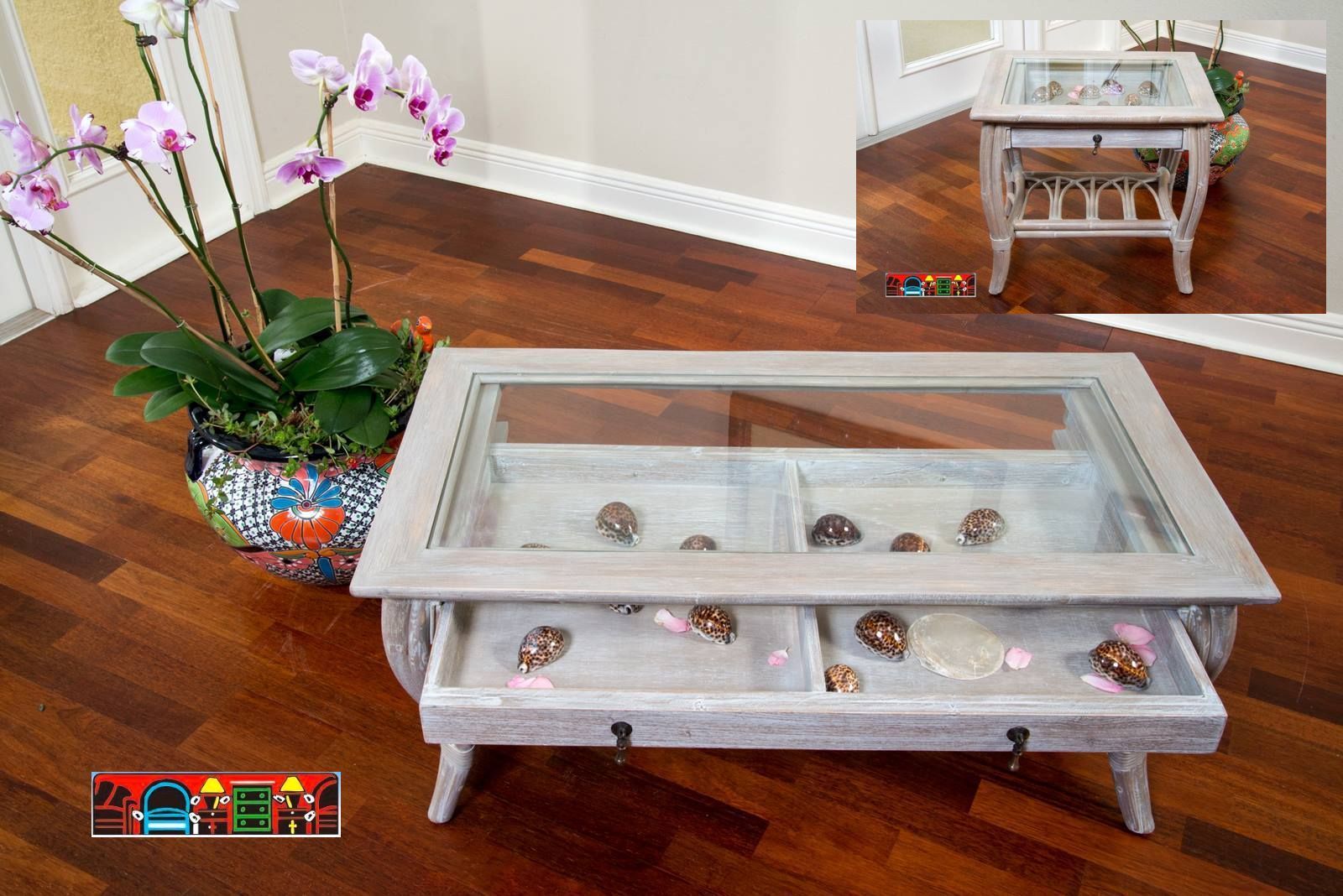 The Coastal Driftwood Cocktail table showcases a rustic rattan pole construction bound with leather, complete with a glass top and two drawers.