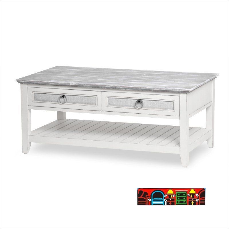 'Casual Cocktail Table: Featuring a two-tone design with a distressed grey top and a weathered-white frame. The drawer fronts are adorned with outdoor fabric, complemented by rope pulls. A bottom shelf provides additional storage, all crafted from solid wood.'