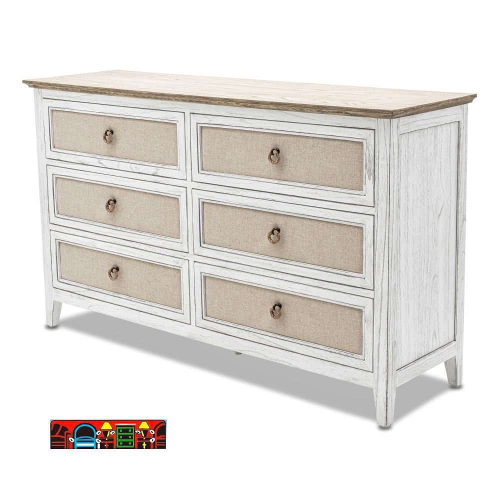 The Captiva Island dresser features a coastal design with a distressed white and beach sand finish, six drawers adorned with outdoor fabric fronts, and woven knobs.
