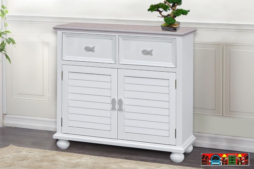 The Fishtails Cabinet, crafted from wood and finished in white with grey accents and top. Features Two drawers, two doors, and a shelf. It is available at Bratz-CFW in Fort Myers, FL.