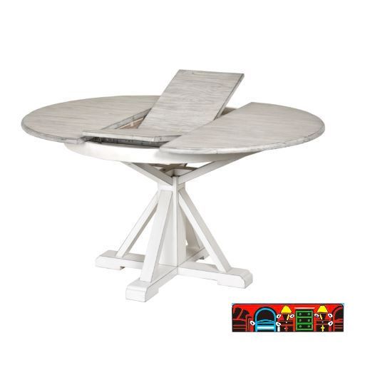 Islamorada white pedestal table featuring a butterfly leaf and a distressed grey finish on the top.
