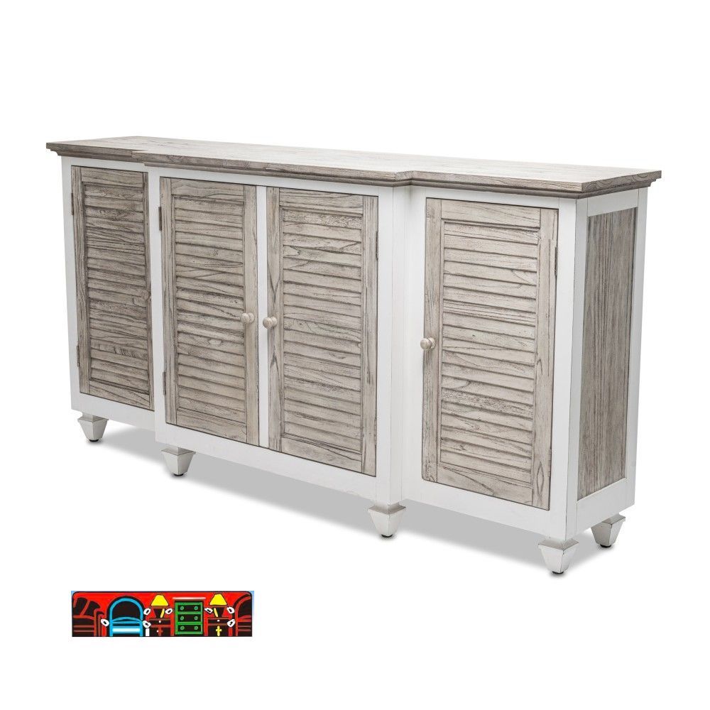 A credenza with four louvered doors in a distressed gray and white finish, featuring a protruding center section and shelves behind.
